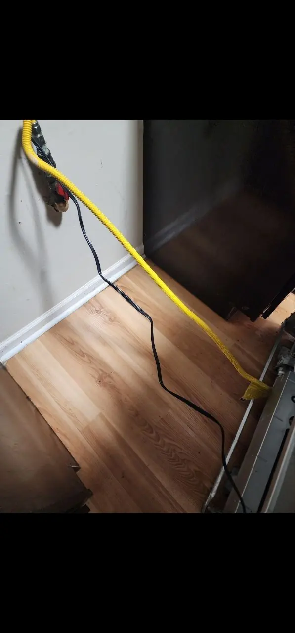 After: floor behind kitchen appliances cleaning