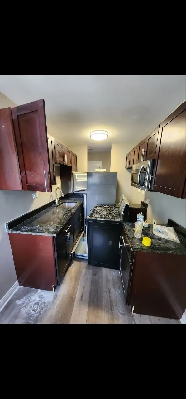 Before: galley kitchen during a move-out cleaning